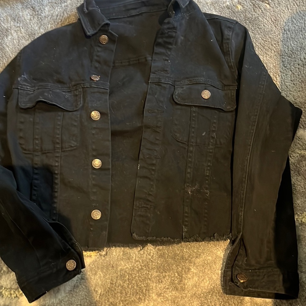 black jean jacket with mouth on the back
